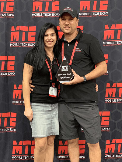 Miro and Victoria taking photo with 1st place trophy at MTE Expo 2021